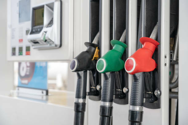 red green black color fuel gasoline dispenser background close up fuel nozzles on petrol and